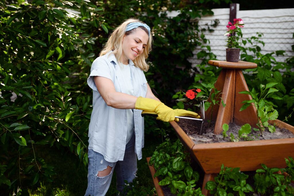 woman-with-hoe-at-the-flowerbed-in-the-garden-QX3XMJH.jpg